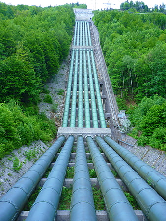 Hydropower Plant Pressure Pipes Descending Through Lush Green Forest