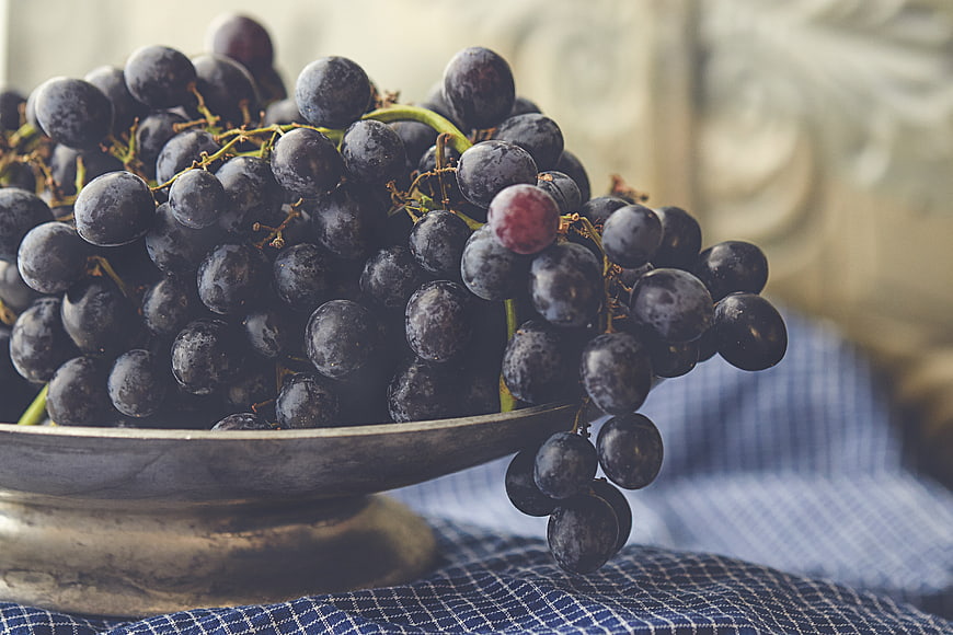 Fresh Purple Grapes in Rustic Silver Bowl