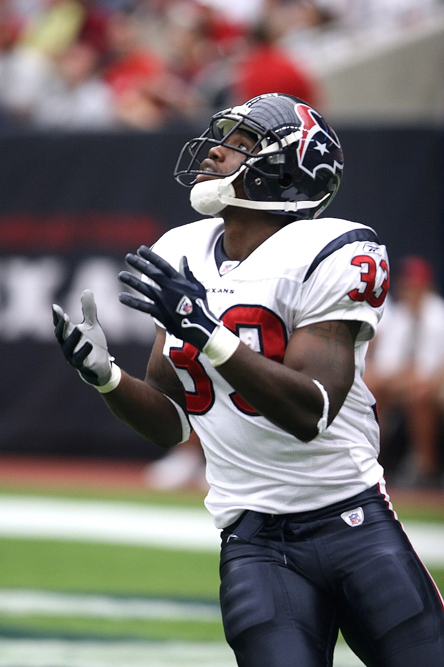American Football Player Catching Ball in White Jersey