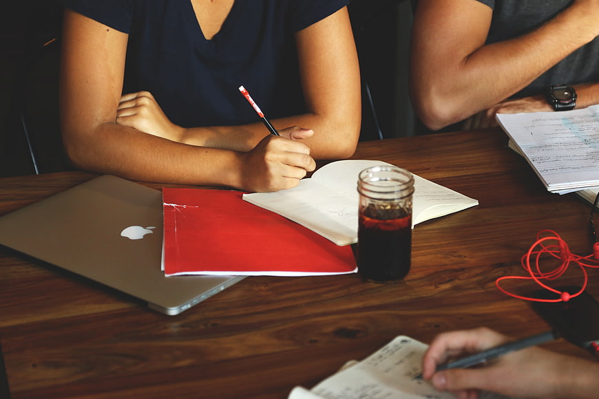 Teamwork meeting with laptop and coffee on wooden table