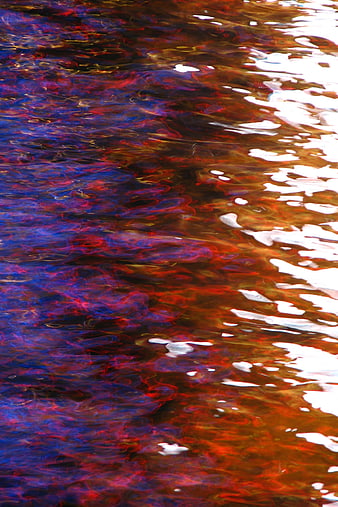 Abstract colorful water ripples with neon reflections