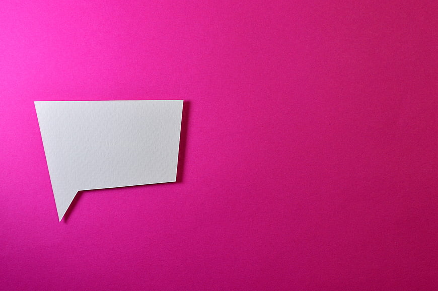 White paper speech bubble on vibrant pink background