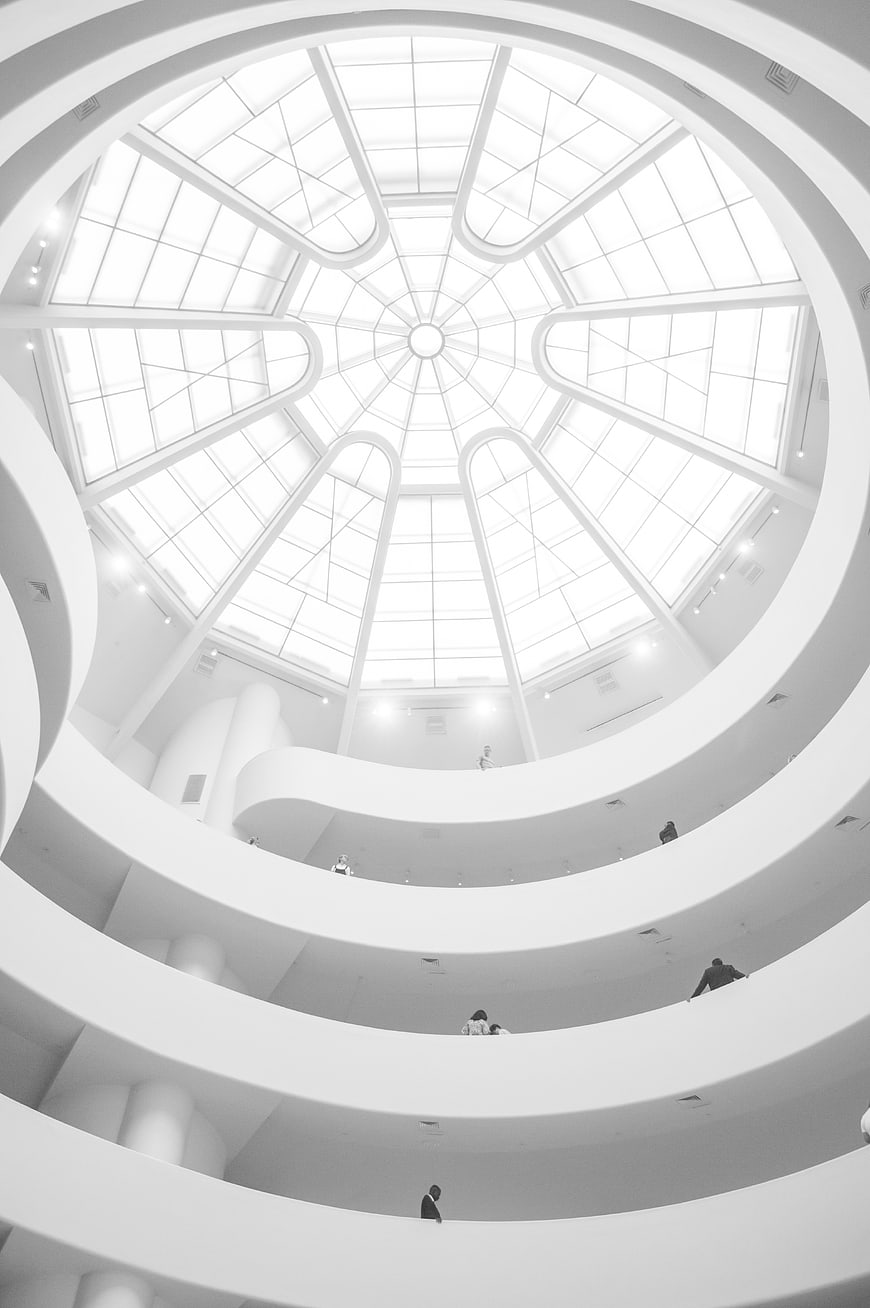 Black and white spiral staircase interior with skylight
