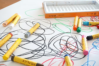 Colorful Crayons And Scribbles On White Paper