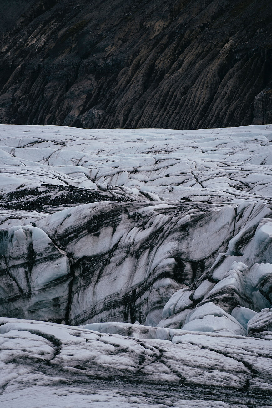 Dramatic glacier landscape with dark volcanic rock ridges