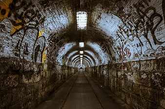 Gritty graffiti tunnel with perspective leading lines
