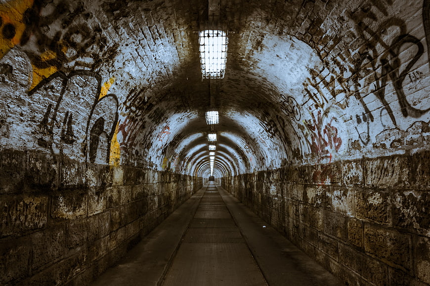 Gritty graffiti tunnel with perspective leading lines