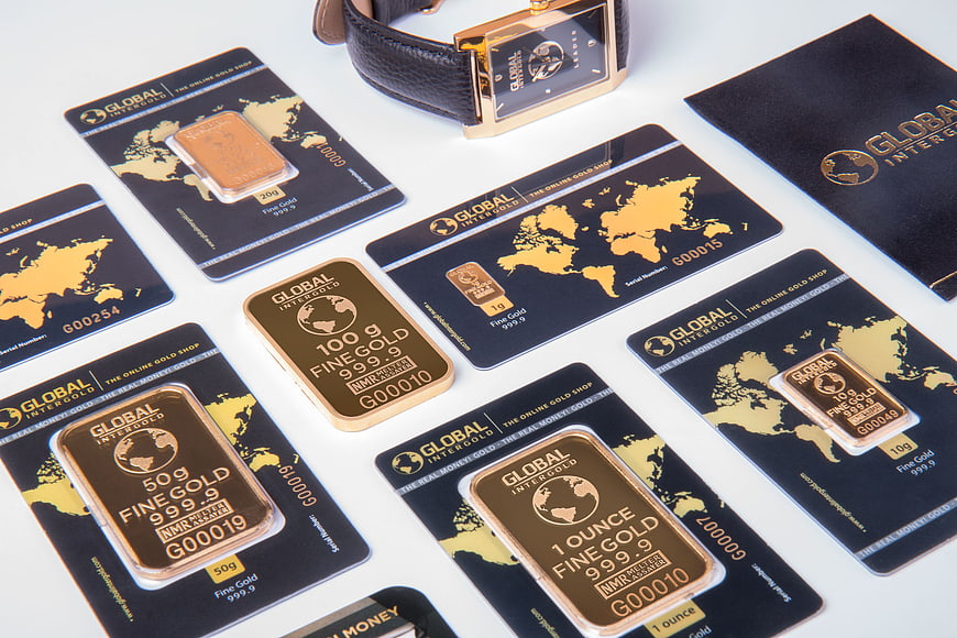 Gold bars and certificates with luxury watch on white background