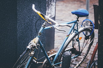 Vintage Blue Bicycle Parked on Cobblestone Street