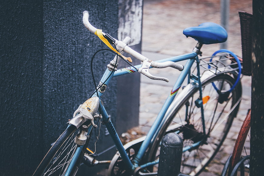Vintage Blue Bicycle Parked on Cobblestone Street