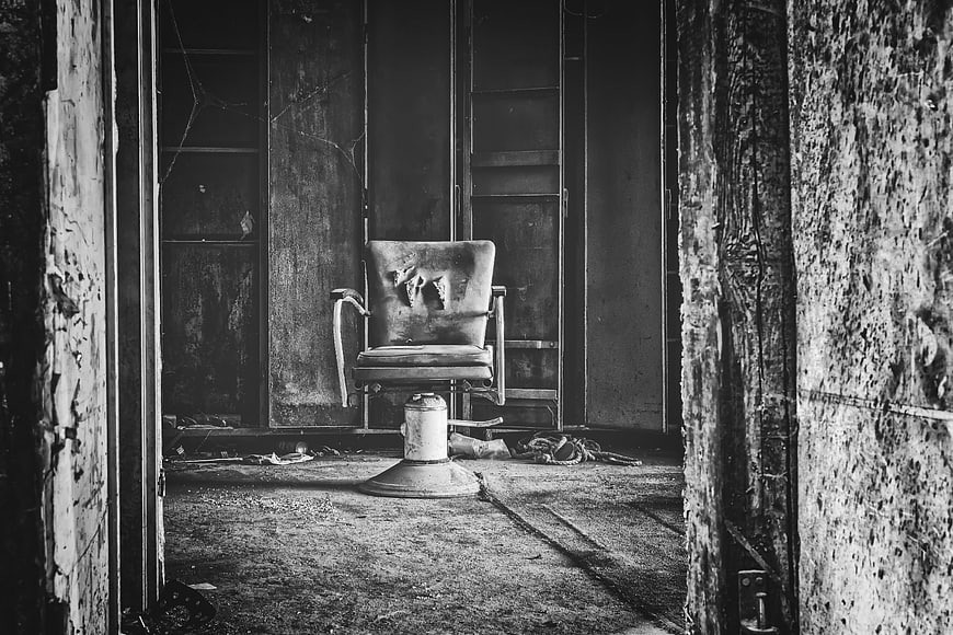 Abandoned Interrogation Chair in Dark Decaying Room