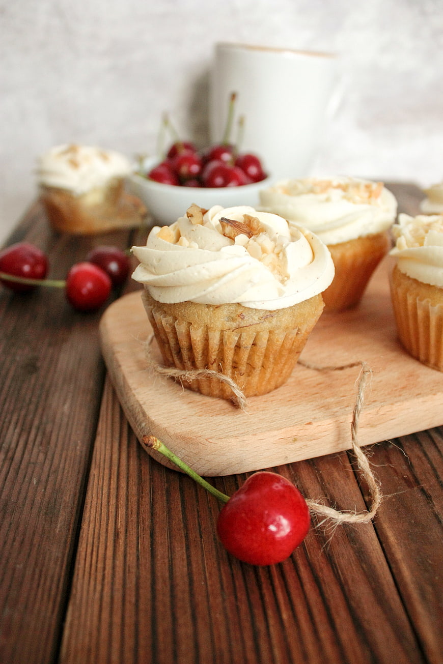 Vanilla Cupcakes with Cream Frosting and Fresh Cherries