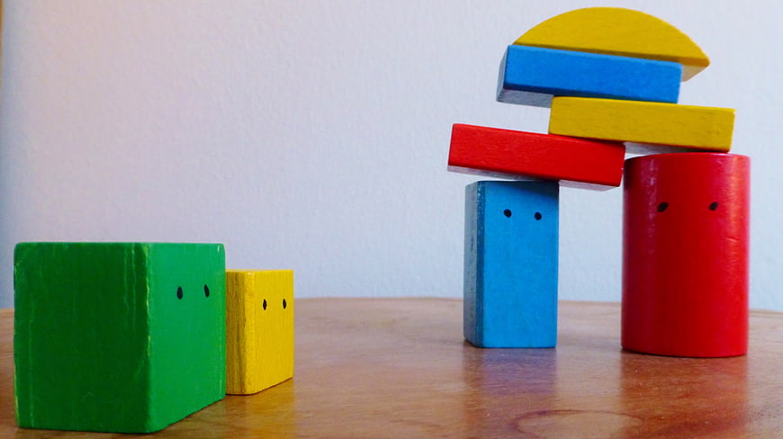 Colorful Wooden Building Blocks Arranged As Playful Characters