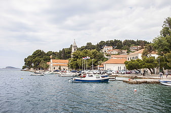 Scenic coastal town harbor with boats and church tower
