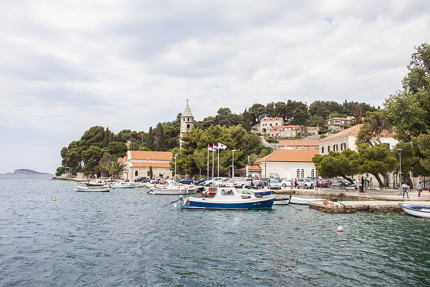 Scenic coastal town harbor with boats and church tower