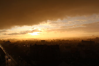 Dramatic Golden Sunset Over Silhouetted City Skyline