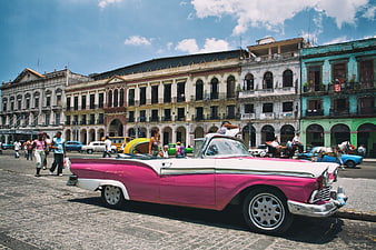 Pink and white vintage convertible car in Havana street