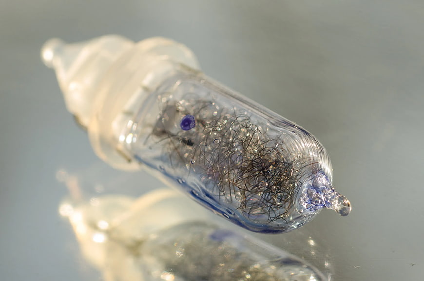 Close-up of vintage filament light bulb with blue glass