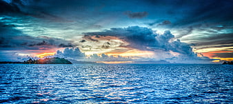 Dramatic Sunset Over Tropical Ocean with Distant Island