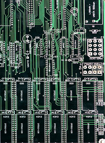 Close-up of green printed circuit board with electronic components and traces