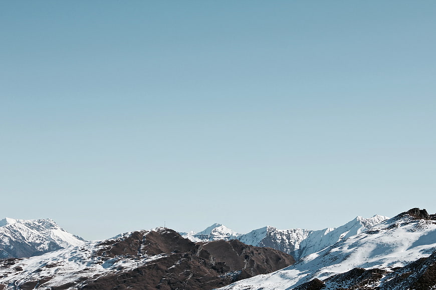 Snowy Mountain Peaks Under Clear Blue Sky
