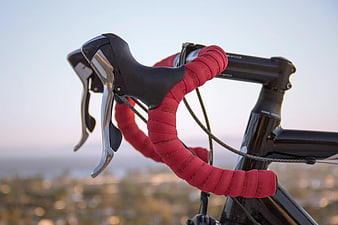 Close-up of red wrapped road bike handlebars