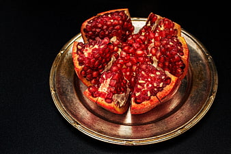 Fresh Pomegranate Segments on Vintage Brass Plate