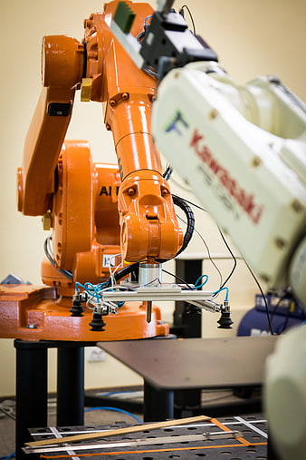 Orange industrial robotic arm with sensor array in laboratory setting