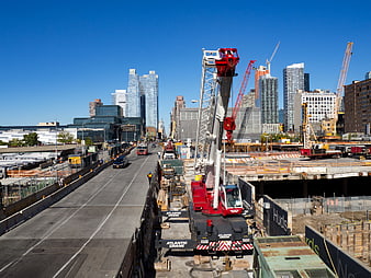 Urban Construction Site with Cranes and City Skyline
