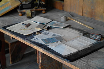 Vintage Printing Press Desk with Old Tools and Paper