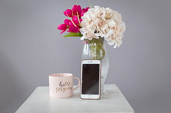 Pink Mug and Smartphone with Flowers on White Table
