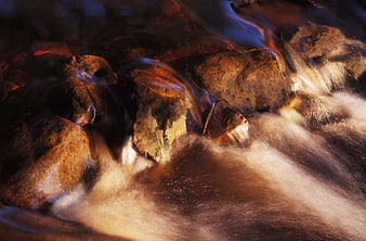 Long exposure flowing water over rocks in a stream
