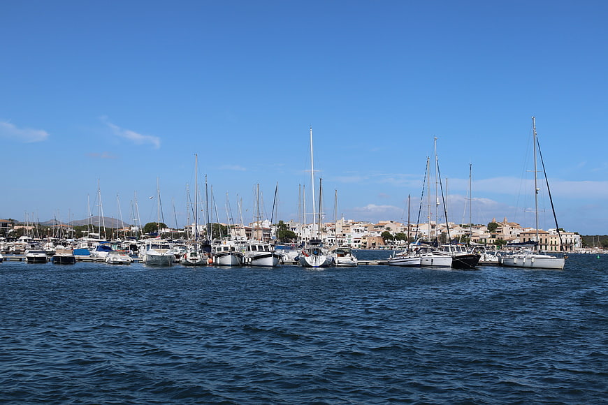 Mediterranean Harbor With Sailboats And Coastal Town