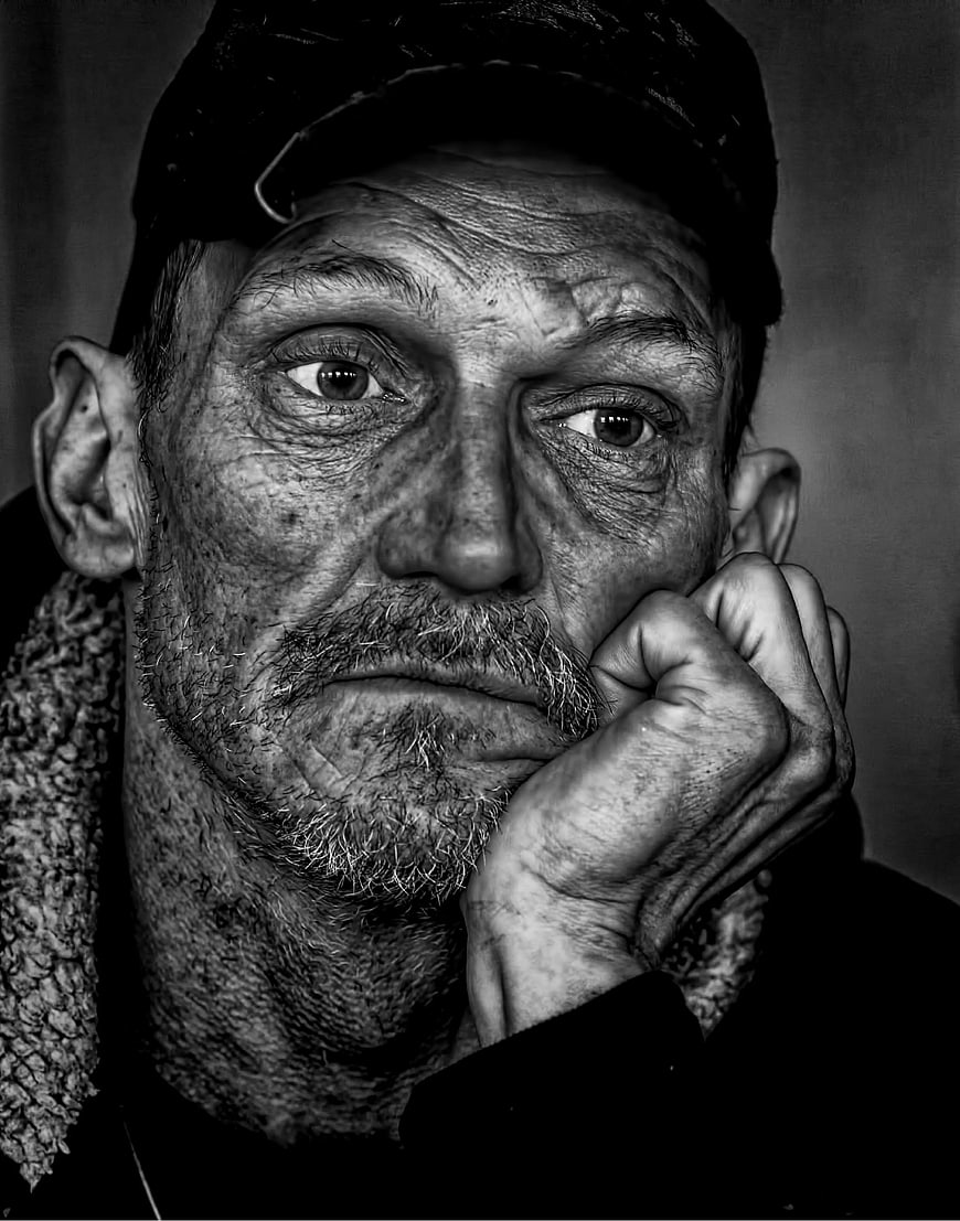 Intense Black and White Portrait of Weathered Man in Cap