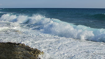 Powerful Ocean Wave Crashing on Rocky Shore