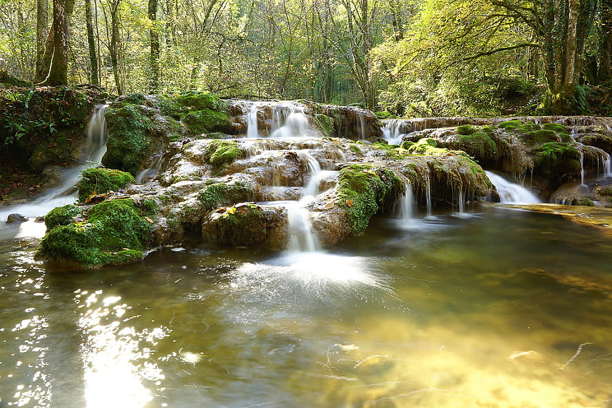 Serene Mossy Waterfall in Lush Green Forest