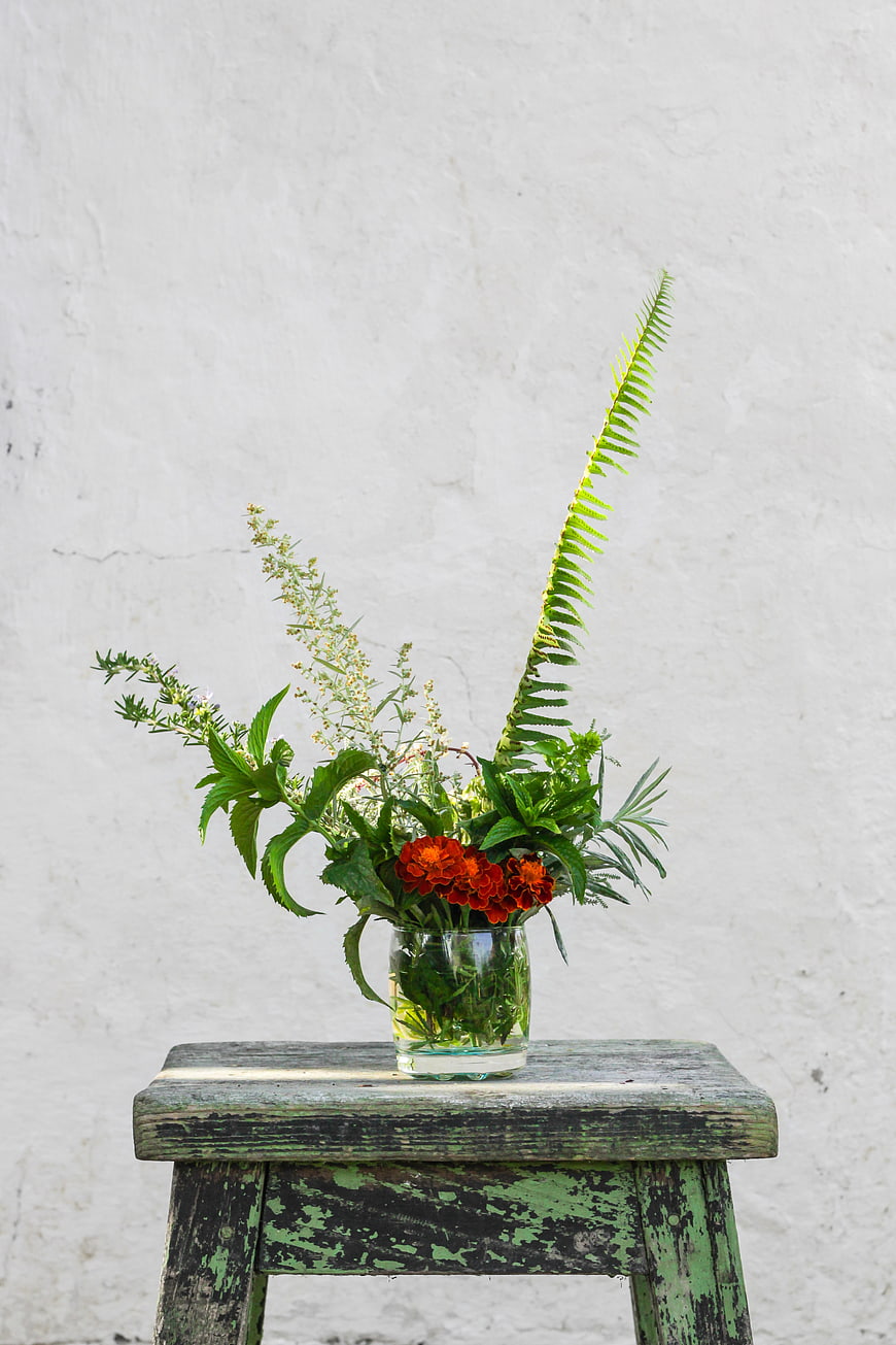 Wildflower Arrangement in Glass Vase on Rustic Wooden Stool