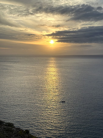 Serene Ocean Sunset with Golden Sunlight Reflection on Water