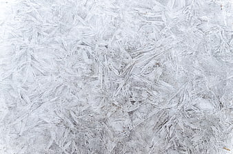Close-up of intricate ice crystals and frost patterns on frozen surface