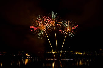 Colorful Fireworks Display Over City Skyline at Night