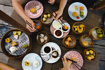 Top View of Hands Eating Chinese Dim Sum Feast