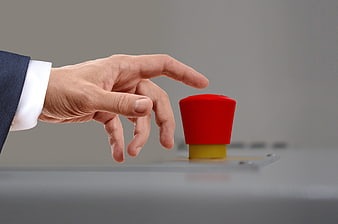 Hand About to Press Red Emergency Button