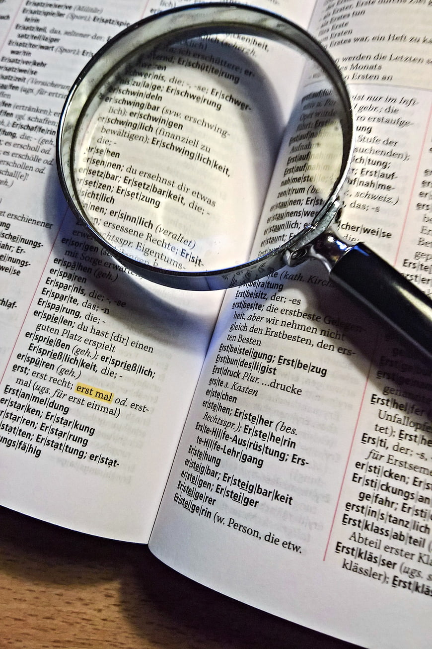 Magnifying glass over German dictionary page