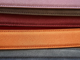 Stack of colorful suede leather strips with stitching