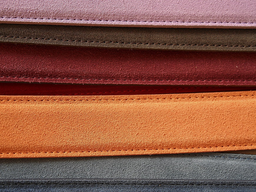 Stack of colorful suede leather strips with stitching