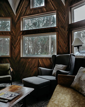 Cozy Cabin Interior with Wood Paneling and Forest View