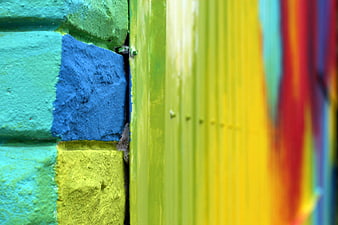 Colorful painted brick wall corner with abstract background