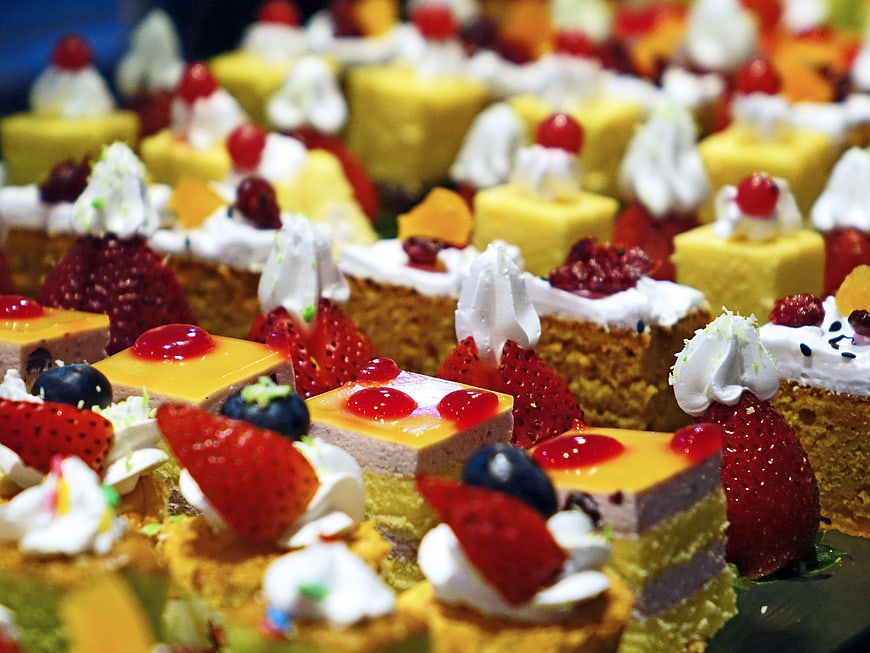 Assorted dessert buffet with fruit cakes and cream