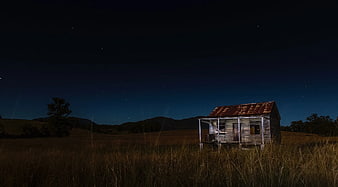 Abandoned Rustic Shack Under Starry Night Sky