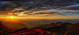 Dramatic Sunset Over Rolling Mountain Ridges